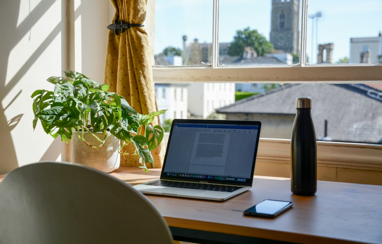 Bright office desk with laptop and bottle during a focused work moment