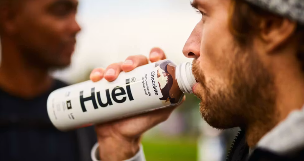 Mainstream consumer drinking a ready to drink protein bottle