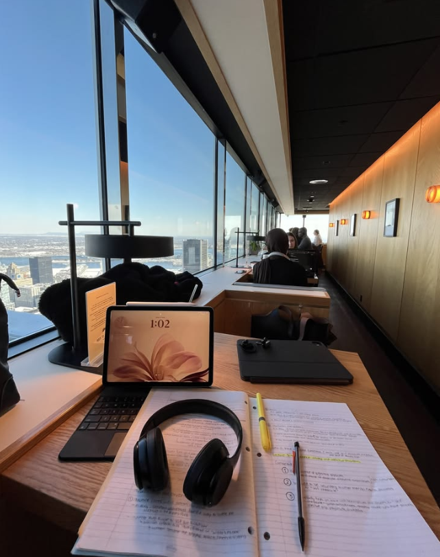 Office desk with notes, tablet and headphones